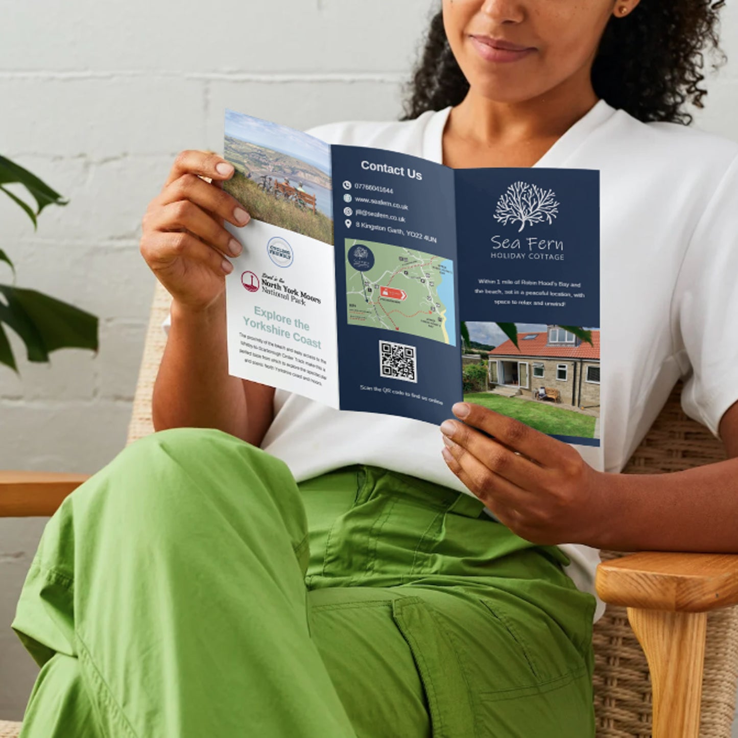 lady reading a trifold leaflet