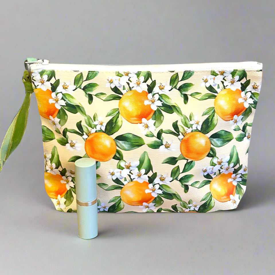 Cute toiletry bag in an orange blossom print with lipstick for scale.