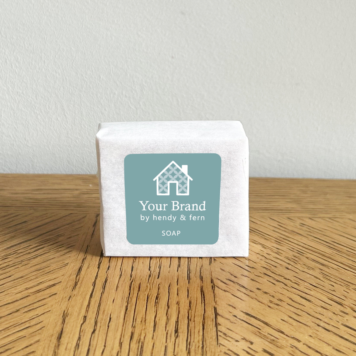 hotel bar soap with custom logo on a wooden surface