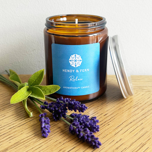 200g aromatherapy soy candles in an amber glass jar with lavender and sage sprigs. 

