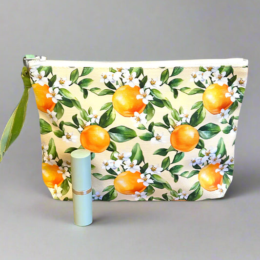 Cute toiletry bag in an orange blossom print with lipstick for scale.